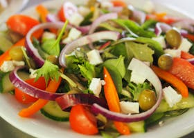 A vibrant Mediterranean salad featuring fresh vegetables, olives, and feta cheese for a healthy meal.